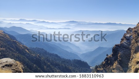 The view you see when you go for trek to Chopta, Uttarakhand. Chopta is a beautiful hill station and a tourist spot. It offers you the best views, plenty of snowfalls and a view of gigantic Himalayas. Royalty-Free Stock Photo #1883110963