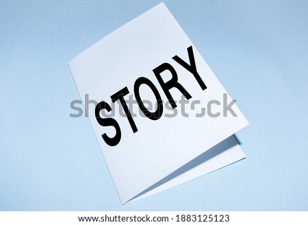 Written by STORY, ON a BLUE BACKGROUND, a business concept of the activity of writing stories to publish them to the public.