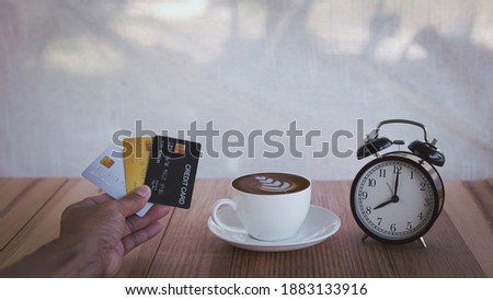 Business man hand hold credit card to shopping online bill , Debit saving purchase buy on table background. People contact less pay money in restaurant, Person bank smart payment concept. 