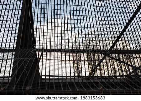 Metal cage in a prison at sunset.
