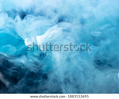 Blue smoke isolated on black background. Abstraction