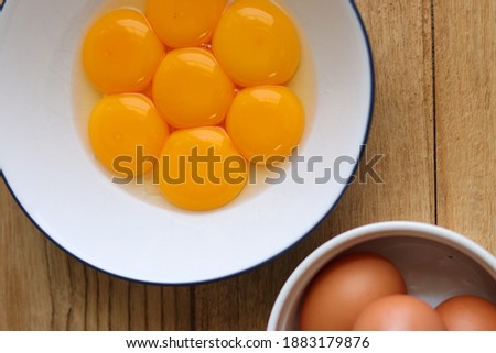 Eggs yolks for baking preparing serve in the bowl on the wooden table