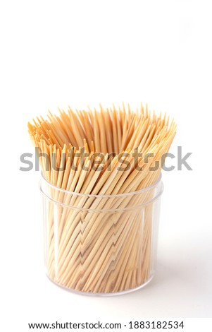 Group of Toothpick in container isolated on white background,  Toothpick is a piece of wooden, small, short stick and peaked, It's device for removing food particles or dirt between teeth. Tableware. Royalty-Free Stock Photo #1883182534