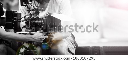 Film industry. Filming with professional camera. Videographer holding 4k cam on dslr rig or gimbal stabilizer set. Pro equipment helps to make videos without shaking. video production. Royalty-Free Stock Photo #1883187295