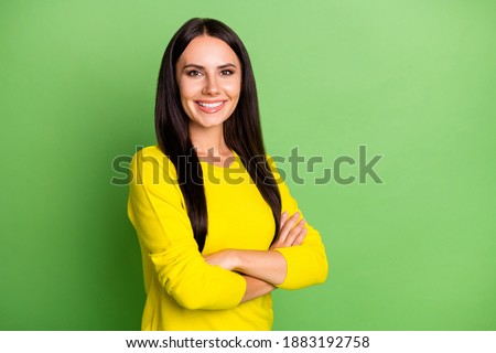Photo of half turned person crossed hands toothy smile look camera isolated on green color background