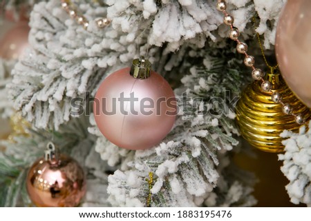 Beautiful New Year's ball hangs on a tree with lights. New Year. Lots of lights and balls. Beautiful Christmas tree of White color