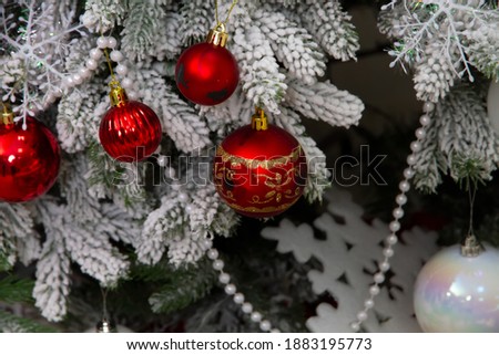 Beautiful New Year's ball hangs on a tree with lights. New Year. Lots of lights and balls. Beautiful Christmas tree of White color
