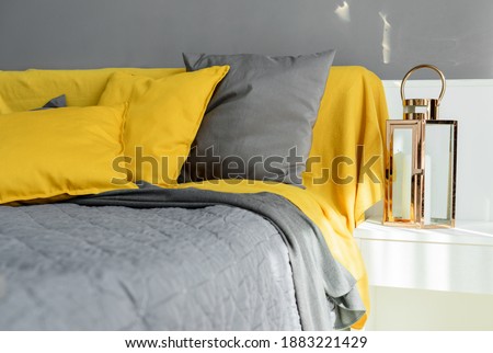 Color pillows illuminating ultimate gray pile on bed Two trendy 2021 colors of years Modern interior design bedroom textile Royalty-Free Stock Photo #1883221429