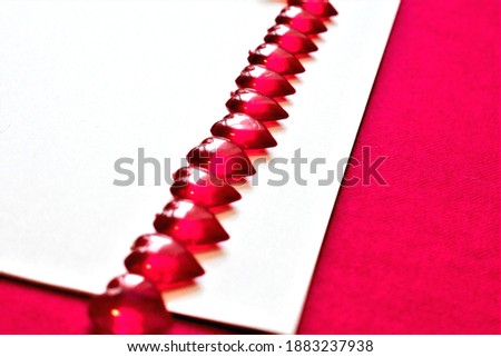 banner for Valentine's Day. white paper and red hearts on a red background
