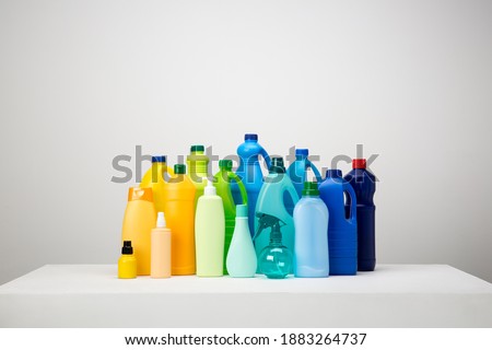 Still life of different types of plastic packaging on white and grey set arranged by colours Royalty-Free Stock Photo #1883264737