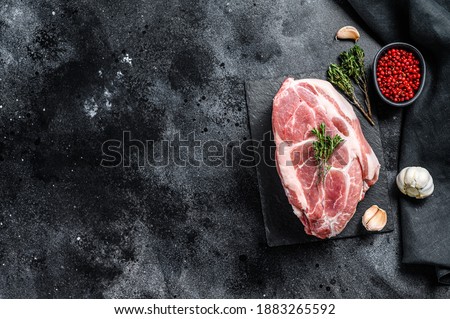 Raw pork neck meat. Chop steak. Black background. Top view. Copy space Royalty-Free Stock Photo #1883265592
