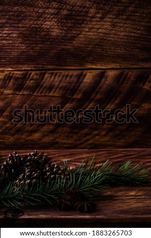 Christmas cones and branches on wooden boards