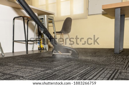 Professional Steam Carpet Cleaning - Hot water extraction carpet cleaning using a wand Royalty-Free Stock Photo #1883266759