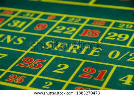 European roulette on a green surface with a classic betting grid. Red and black casino squares. Casino gambling.