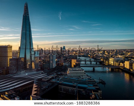 Aerial View over Shard, London Bridge Station, Thames River during sunset Royalty-Free Stock Photo #1883288386