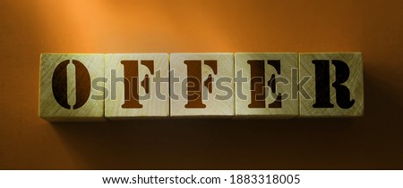 Offer word on wooden cubes on red background. Business concept.