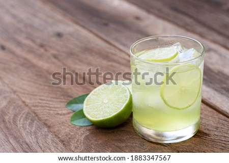 Fresh lemonade mojito or lemon  lime juice isolated on wood table background.