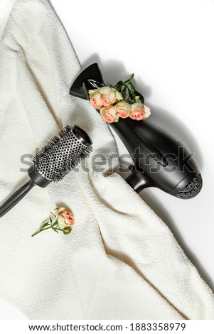 composition with hairdressing tools and flowers on a white background. Template for a postcard or information about a hair salon. flat lay, copy space