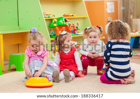 Little girls playing with toys in the playroom