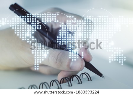 Abstract creative world map with connections and man hand writing in notebook on background, international trading concept. Multiexposure