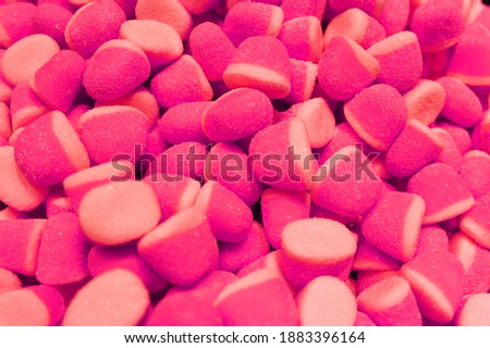 Candy A lot of sweets. Colorful texture using a background. Background rendering. Bright multiple jelly candies in powdered sugar. Confectionery wallpaper concept. Copy space. Shallow focus. Close-up