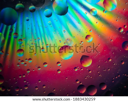 beautiful unreal galaxy in spectral colors consisting oil drops in water.