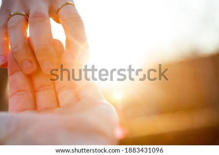 Close up of couple’s hands together. Young married woman and man in love enjoying time together. Concept about lifestyle, people, travel and love. 