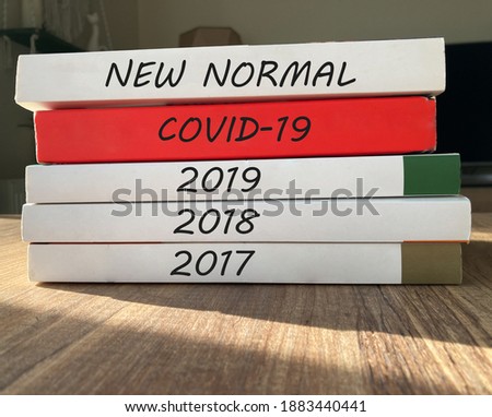 New normal concept with laid up books. Covid year 2020 is ending and 2021 is coming. Happy new year 2021 concept after corona year.