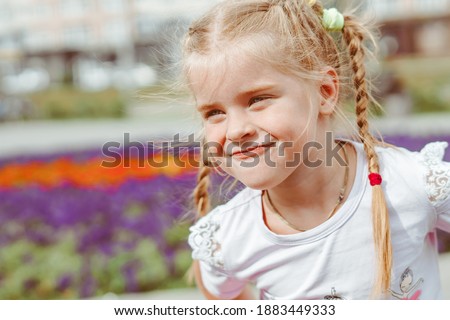 funny girl playing in the Park with pigtails