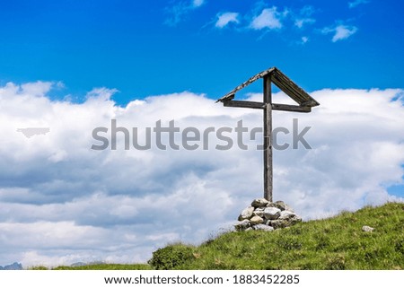 Wooden cross on top of mountain, blue sky, tranquil scene, Austrian alps