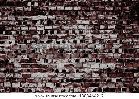 Old grimy brick wall with rough surface, textured industrial background.