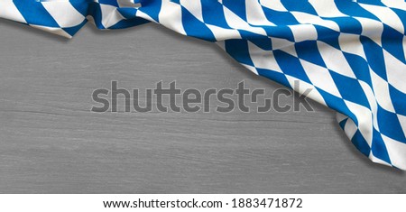 Munich Oktoberfest (germanys biggest event) blue-white Flag on wooden background