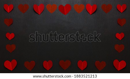 Frame of red paper hearts on a black background. Banner. Festive banner. Copy space