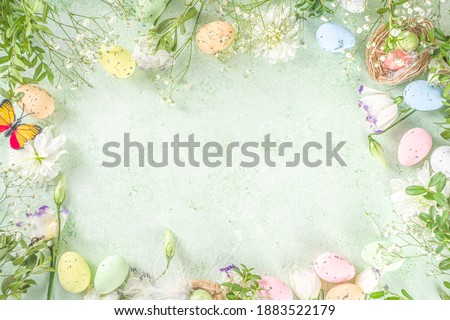 Spring Easter holiday top view  flat lay background with eggs in nests and spring flowers. Greeting card background with copy space. Royalty-Free Stock Photo #1883522179