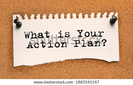 Paper note written with WHAT IS YOUR ACTION PLAN inscription on cork board