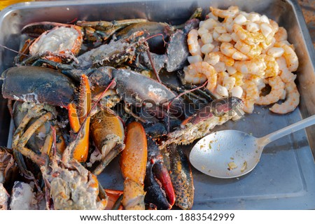 tray of grilled seafood ready for the preparation of a lobster paella