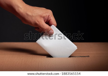 hispanic choosing their vote in latin american political elections on a black background Royalty-Free Stock Photo #1883565154