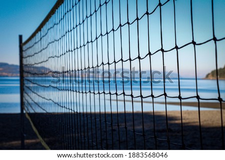 Volleyball net and empty beach. Sea Beach and Soft wave of blue ocean. Summer day and sand background.