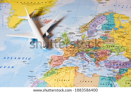 Map of Europe. Travelling by plane. Airplane on a map. Royalty-Free Stock Photo #1883586400