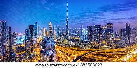 Dubai city center skyline and bussy evening after sunset with colorful sky, United Arab Emirates
