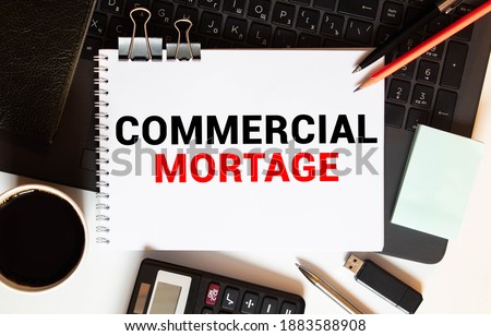 COMMERCIAL MORTGAGE message on the card held by a man hand