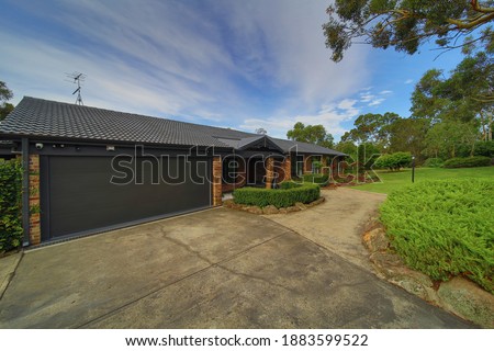 Residential house in Dural a country suburb in Sydney NSW Australia with lush green trees and grass 