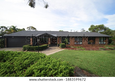 Residential house in Dural a country suburb in Sydney NSW Australia with lush green trees and grass 