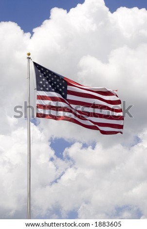 American flag waving in the wind with a beautiful cloud formation behind it - vertical shot
