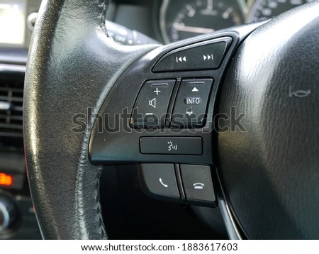 multifunction buttons on steering wheel in a modern car.