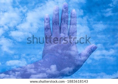 hand in blue sky background