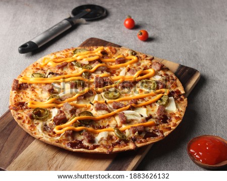 pizza with meat topping, mozzarella cheese, pickle