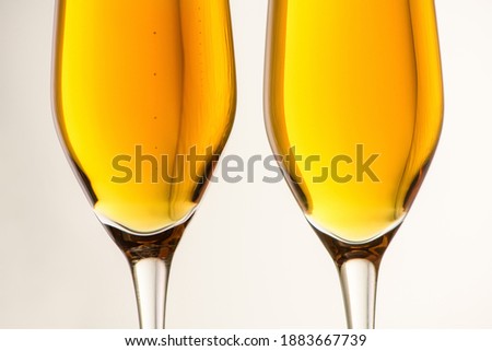 Two glasses of champagne, wine on a gray background. Alcoholic drink: champagne, beer, white wine. New year and Christmas background. Valentine's Day. Silhouette of a glass