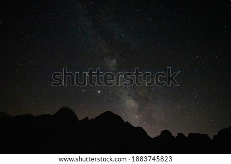Milky way and stars at dark night. Silhouette of the hills. Astrophotography. Milky way background photo.