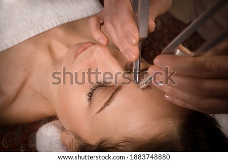 sound healing and facial anti-age massage with tuning forks Royalty-Free Stock Photo #1883748880